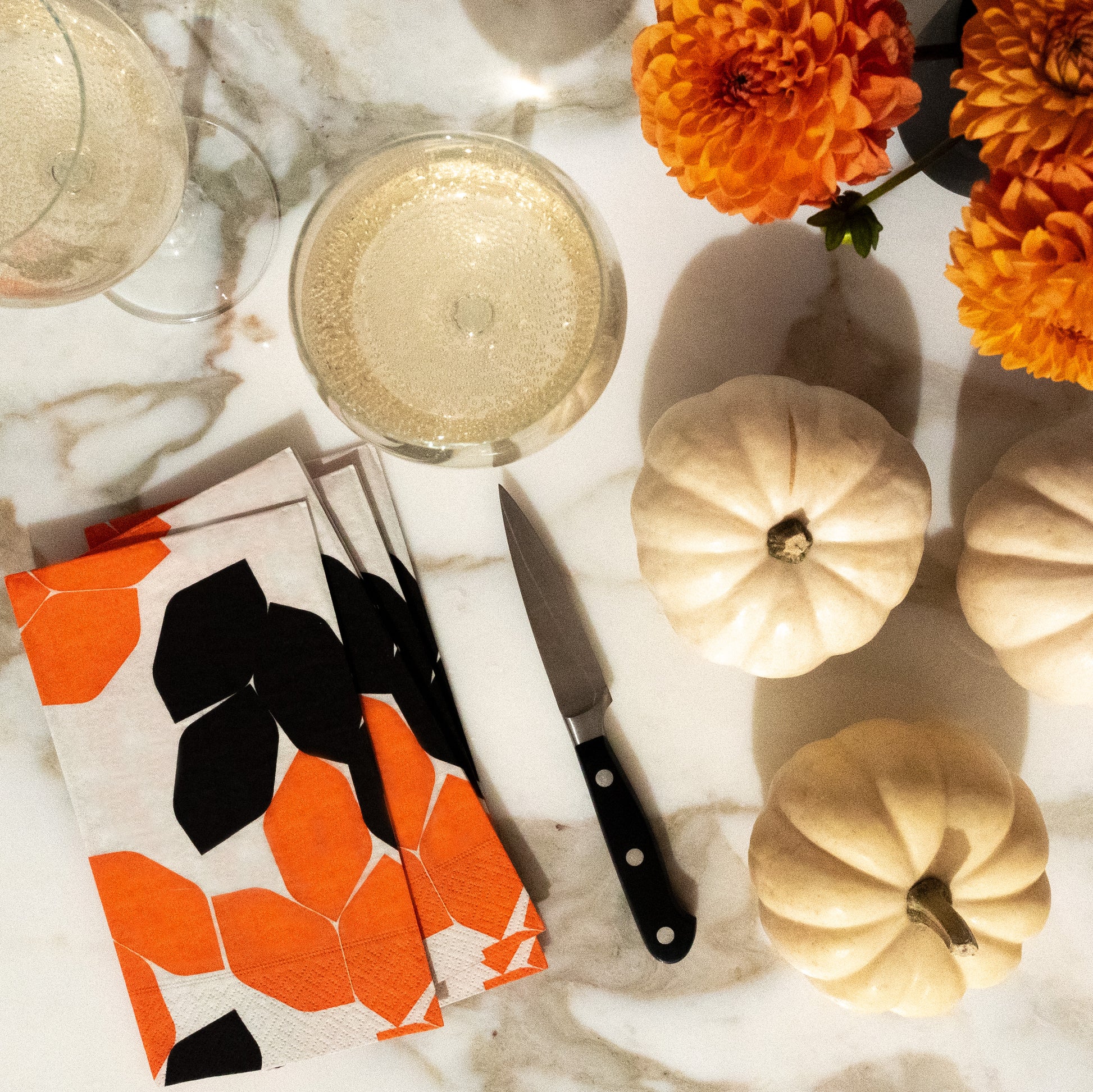 Beige guest towel napkin with orange and black design