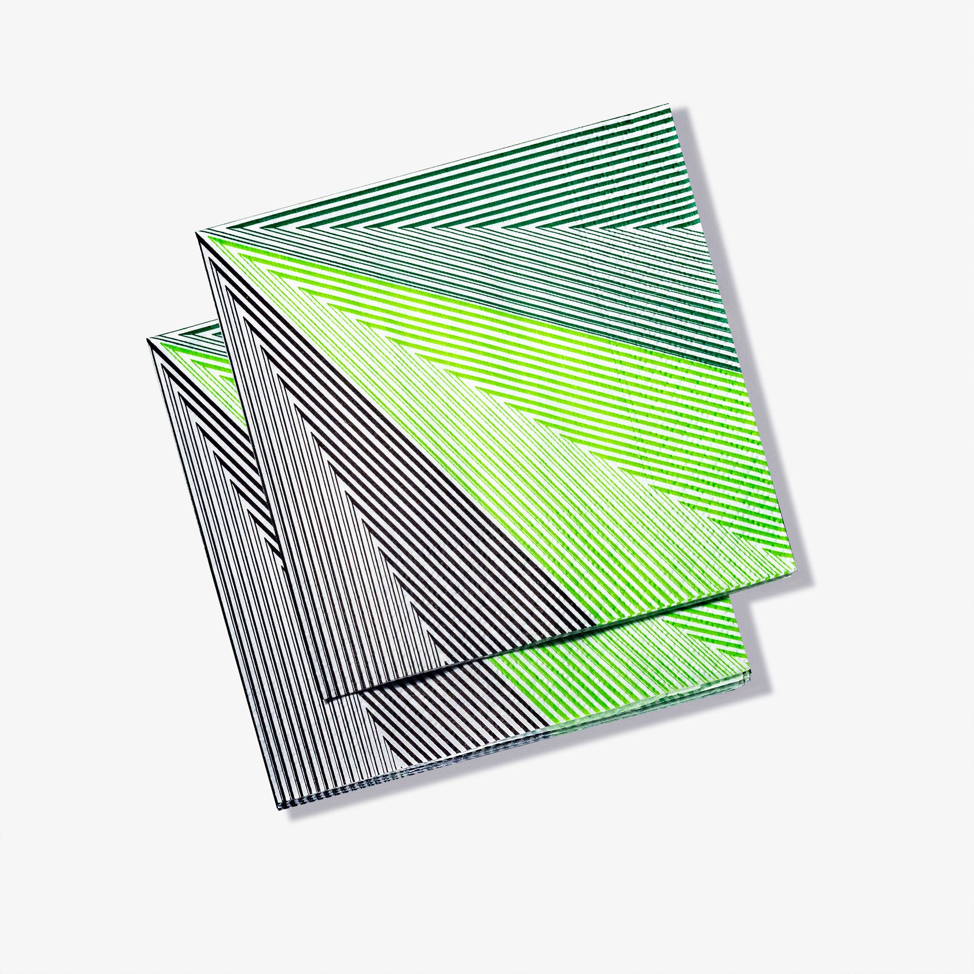 Green, black and white cocktail napkin with striped pattern