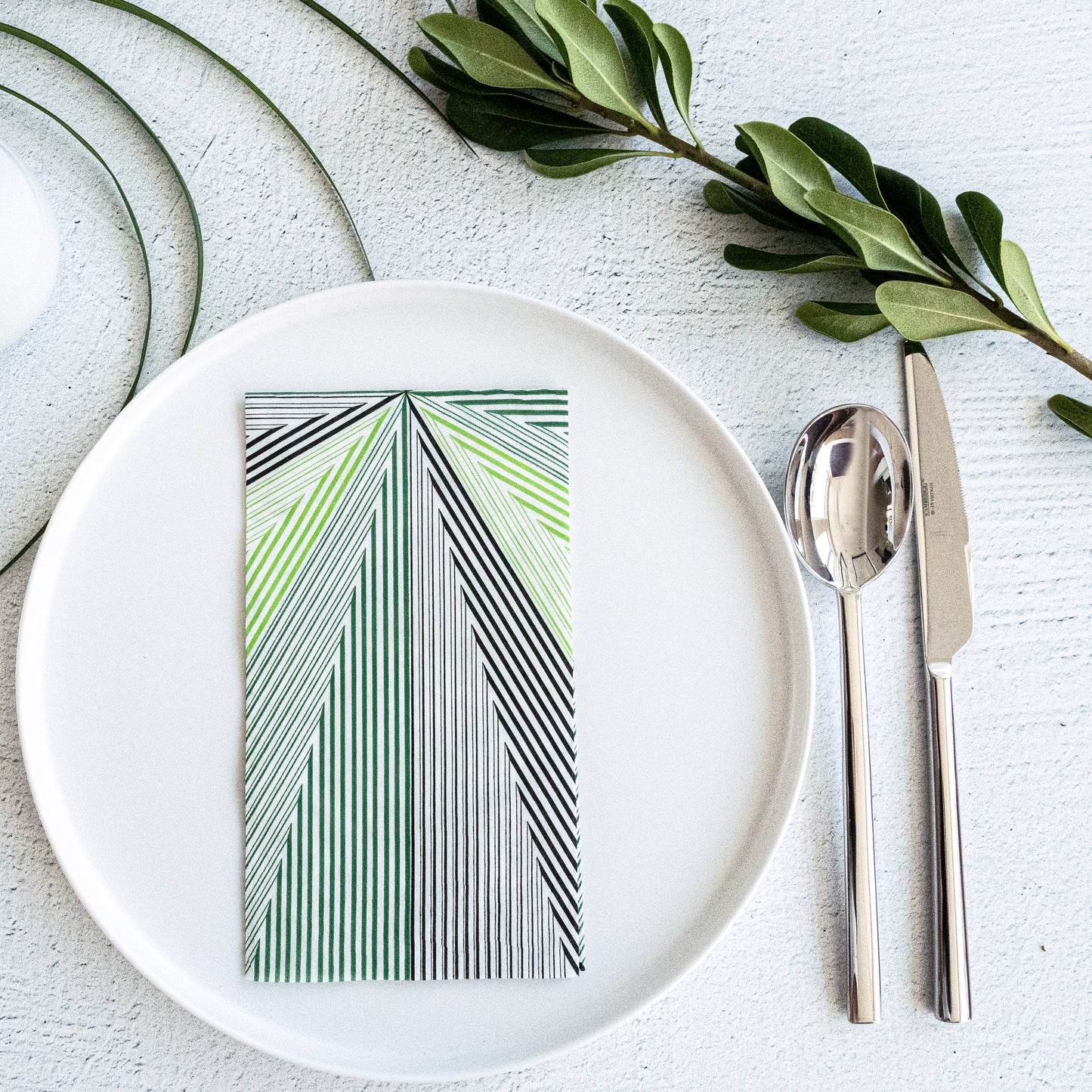 Green, black and white guest towel napkin with striped pattern