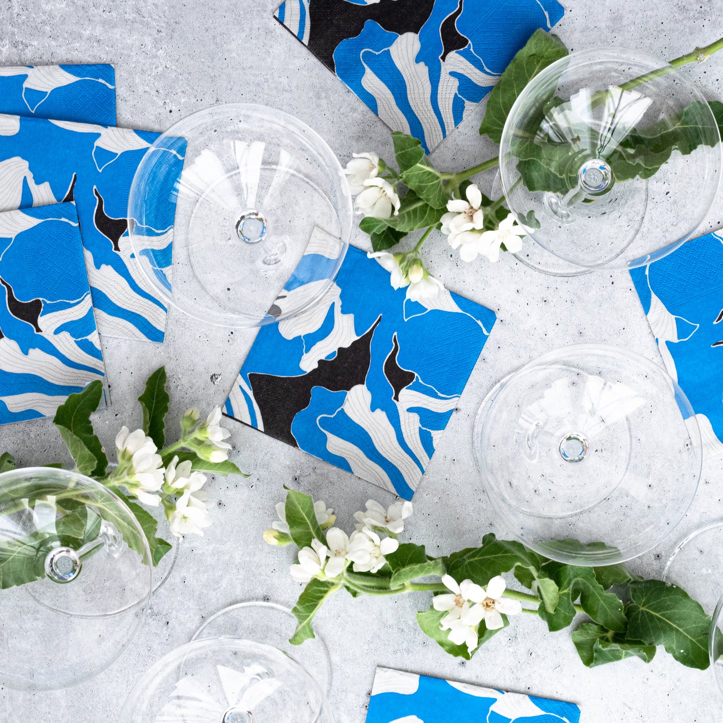 Blue, gray, white and black cocktail napkin with floral pattern