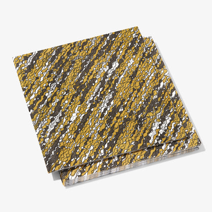 Gold, black and white dinner napkin with abstract pattern
