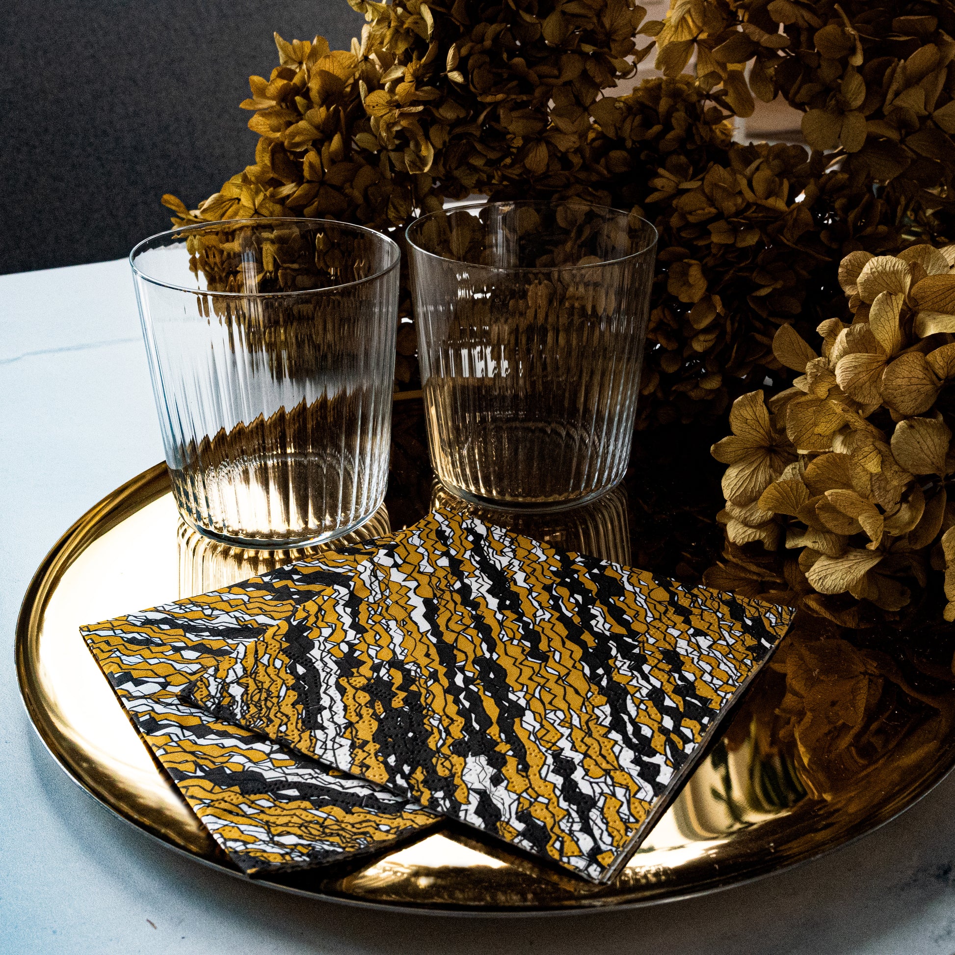 Gold, black and white cocktail napkin with abstract pattern