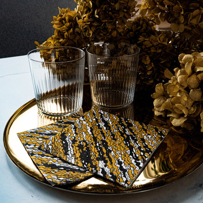 Gold, black and white cocktail napkin with abstract pattern