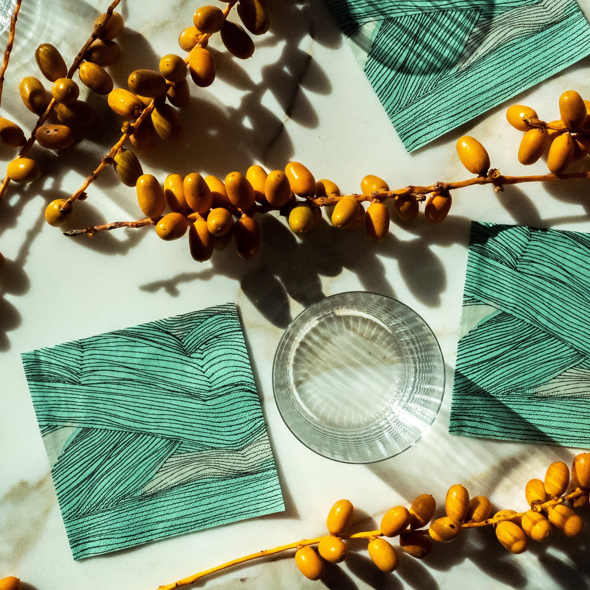 Green, black and off-white cocktail napkin with abstract pattern