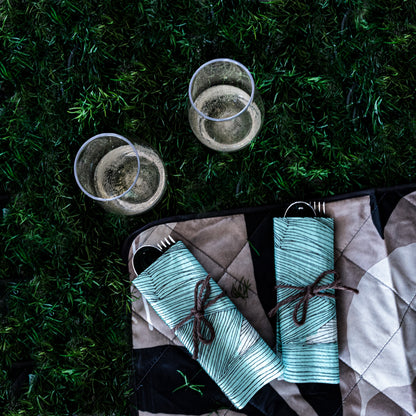 Green, black and off-white dinner napkin with abstract pattern