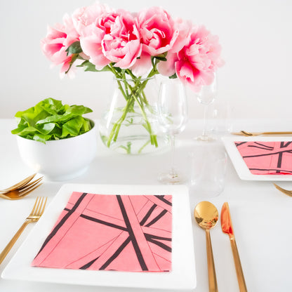 Pink dinner napkin with black striped pattern