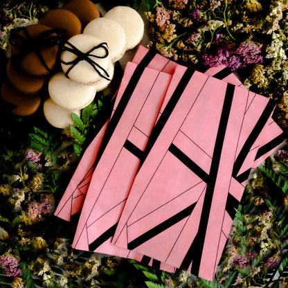 Pink guest towel napkin with black striped pattern